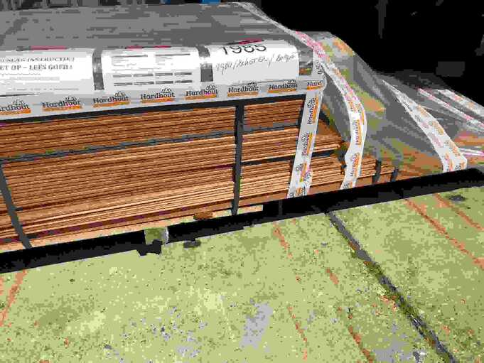 Bundle of hardwood decking boards strapped securely and ready for nationwide transport