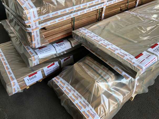 Carefully packaged hardwood products stacked securely on pallets for delivery