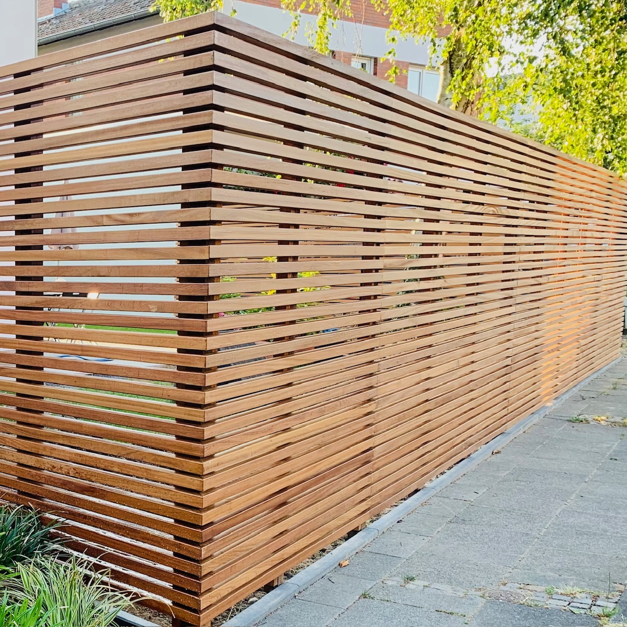 Ipe slatted fence providing clean architectural lines and privacy in a stylish garden