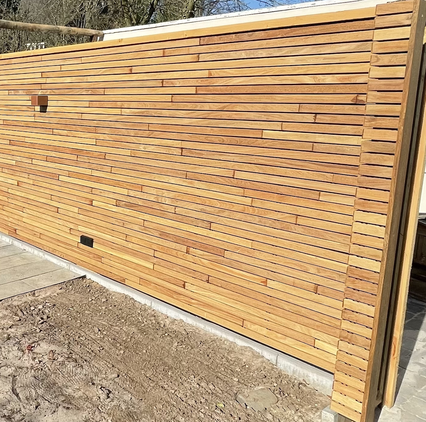 Modern Ipe slatted fence in a luxury garden