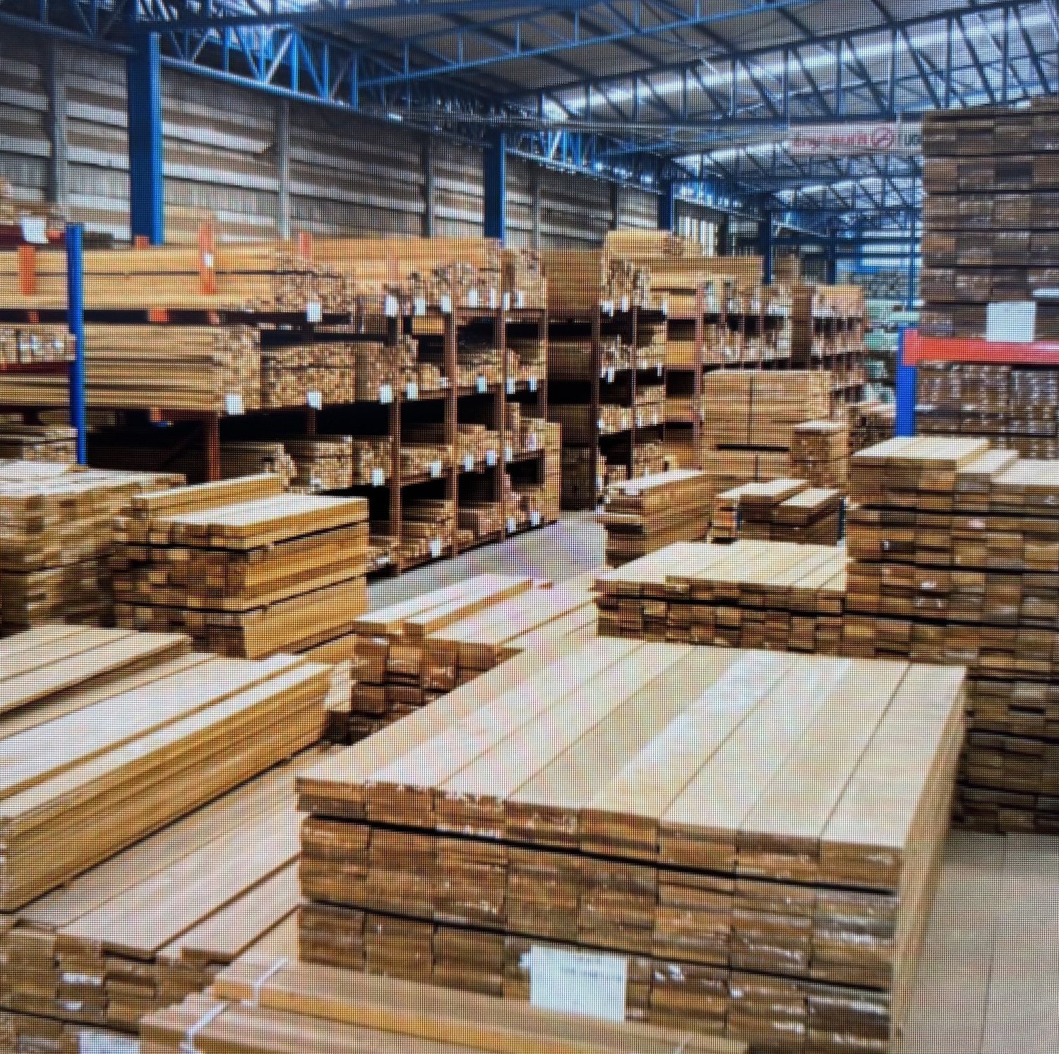 Overview of the extensive timber warehouse with stacks of premium hardwood planks