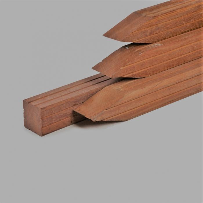 Planed Azobe hardwood posts with a pointed end for installing durable garden fencing