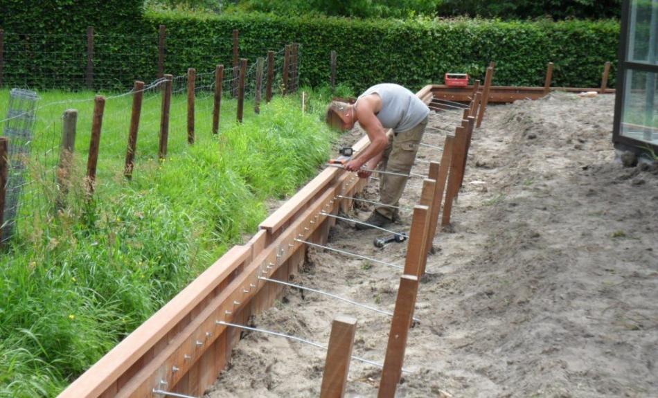 Garden border being constructed with sturdy Ipe hardwood planks and steel anchors