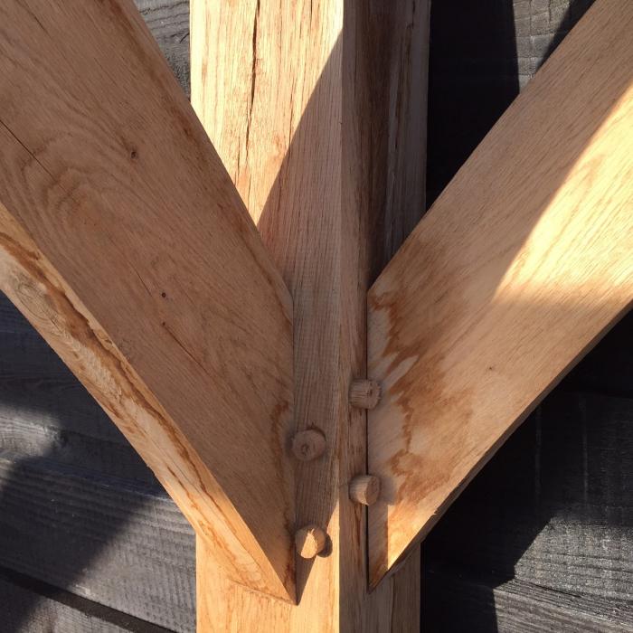 Traditional pegged timber joint crafted for a bespoke Douglas fir and oak canopy