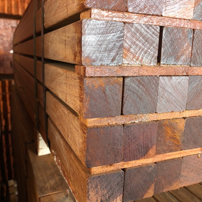Storage bundle of smooth planed Ipe posts separated by battens in the warehouse