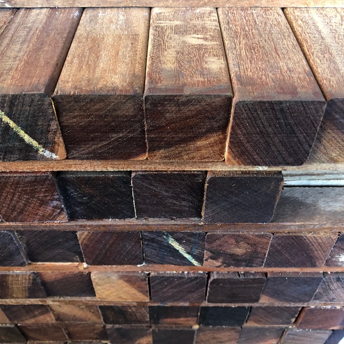 Durable smooth planed Ipe hardwood posts neatly stacked for gate and fence construction