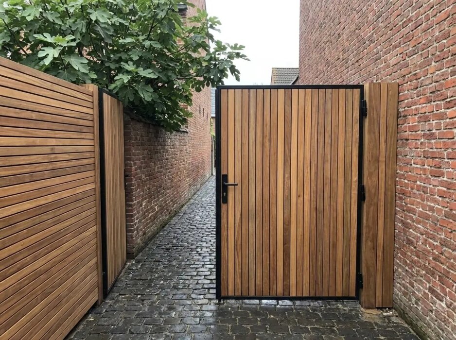 Ipe bespoke gate between brick walls in a town garden
