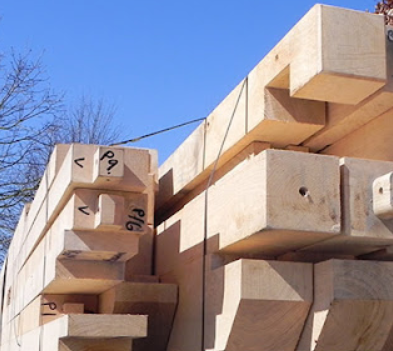 Pre-cut timber frame building kit delivered and prepared for self-assembly on site