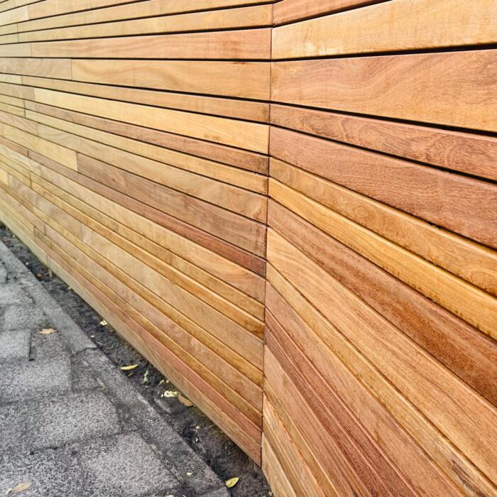 Modern corner arrangement of an Ipé variation fence with slats covering the posts