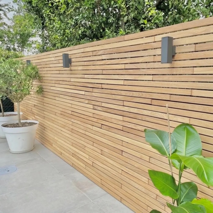 Modern teak fence with 50 mm slats and wall lights