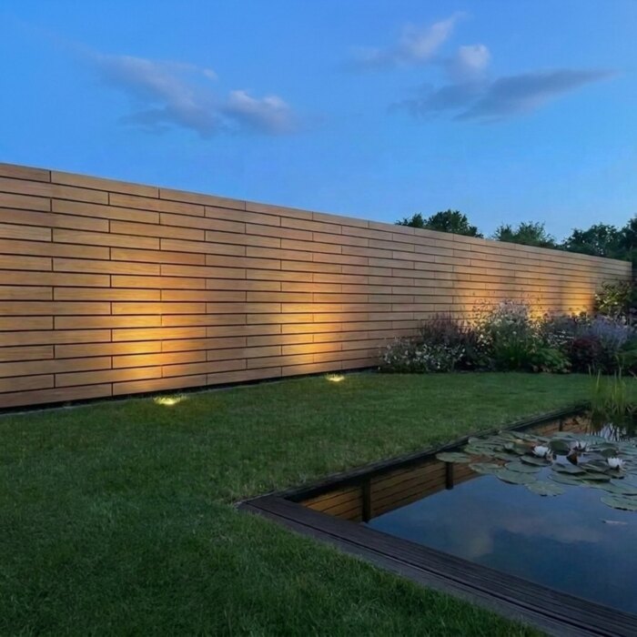 Teak fence with 70 mm slats at night, with no light showing between the slats Teak fence with 70 mm slats at night, with no light showing between the slats