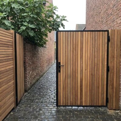 Ipe bespoke gate between brick walls in a town garden