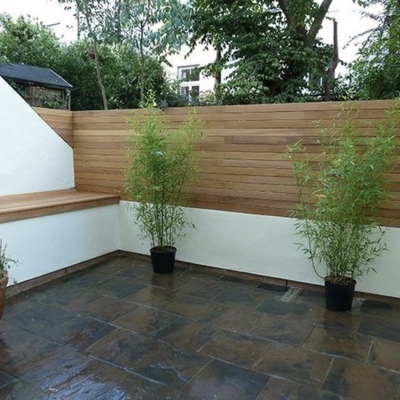 Low hardwood fence made of Ipé, sold as a complete set for installation on a stone wall