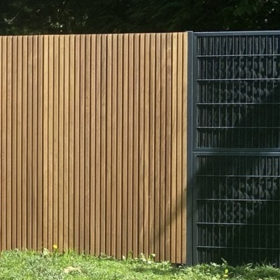 Modern fence of tripple planks IPE WOOD fully enclosed