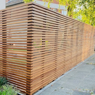 Contemporary Ipe hardwood fence with slanted slats, creating a beautiful shadow gap effect and premium look.