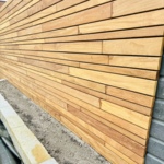Close-up of the concealed fastening of Ipé slats with black Cobra clips.