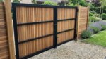 Ipe bespoke double gates clad on one side, back view with black frame