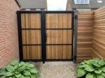 Ipe bespoke gate clad on one side with 90 mm slats, back view