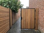 Ipe bespoke gate between brick walls in a town garden
