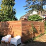 Ipe dream fence made of hardwood in slats or battens, 7 cm wide, with hardwood posts and privacy screen