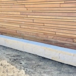 Ipé slatted fence with black EPDM privacy screen for 100% privacy and contrast.