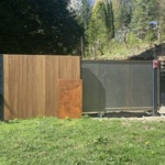 Modern fence vertical of IPE wooden tripple slats fully enclosed fence