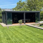 Modern gardenhouse with glass doors and decking