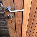 Modern gate of IPE wood with stainless steel lock