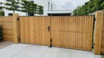 Teak bespoke double gates at a modern house, 50 mm slats