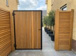 Teak bespoke gate in a side passage, 70 mm slats