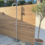 Teak fence with 50 mm slats, outdoor shower and olive tree