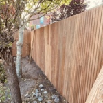 Tripple planks of ipe wood vertically mounted modern fence 