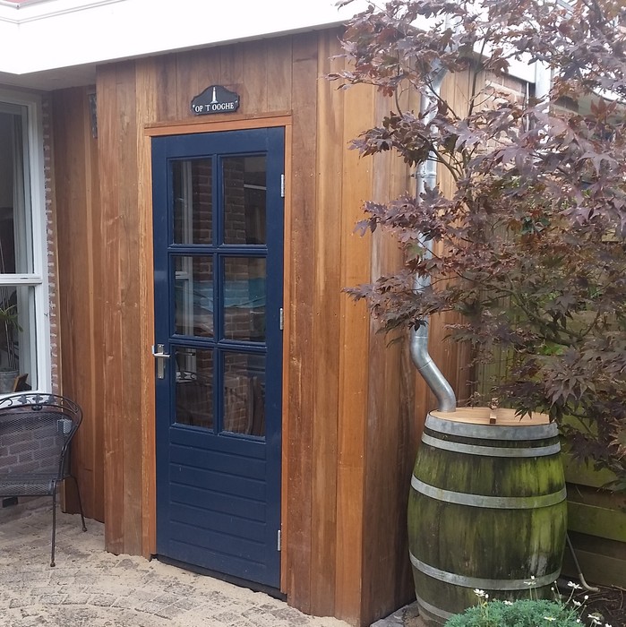 Modern house extension clad with vertical Ipé hardwood slats