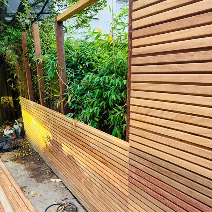 Modern fence completely closed with IPE hardwood tripple planks