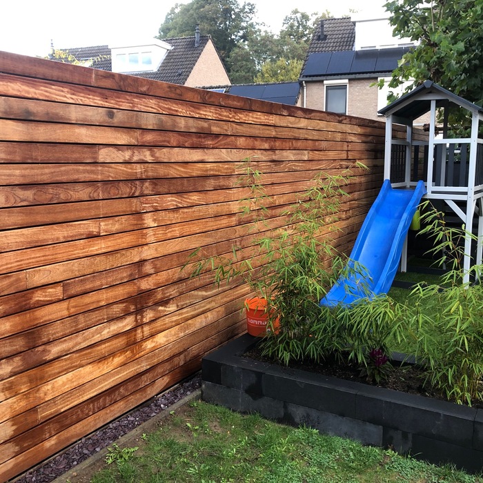Luxury fence made of narrow Ipé hardwood slats invisibly fixed with clips