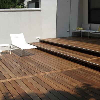 Ipe decking with a raised platform next to a modern house